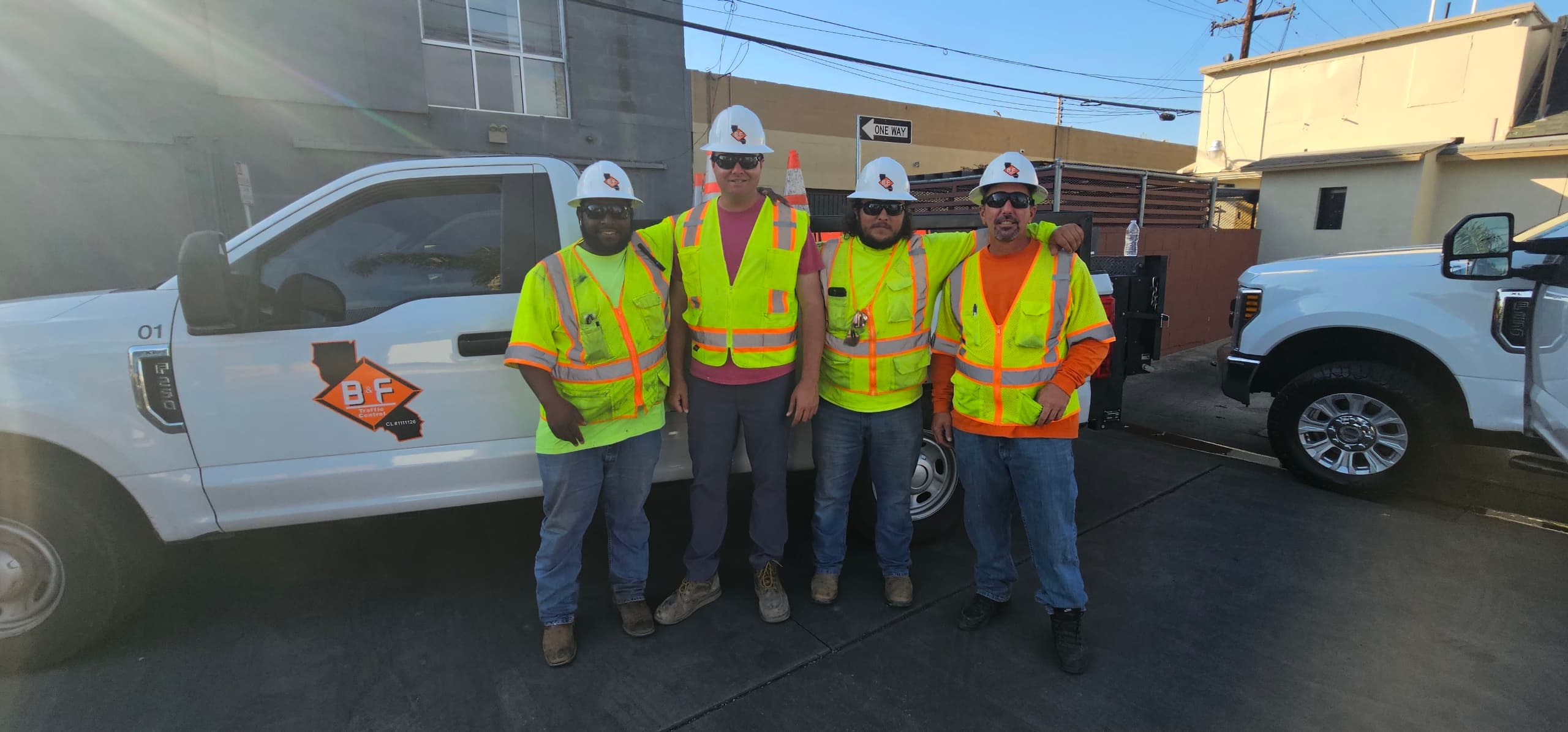 The B&F Traffic Control crew in hard hats and high-visibility vests beside a company truck