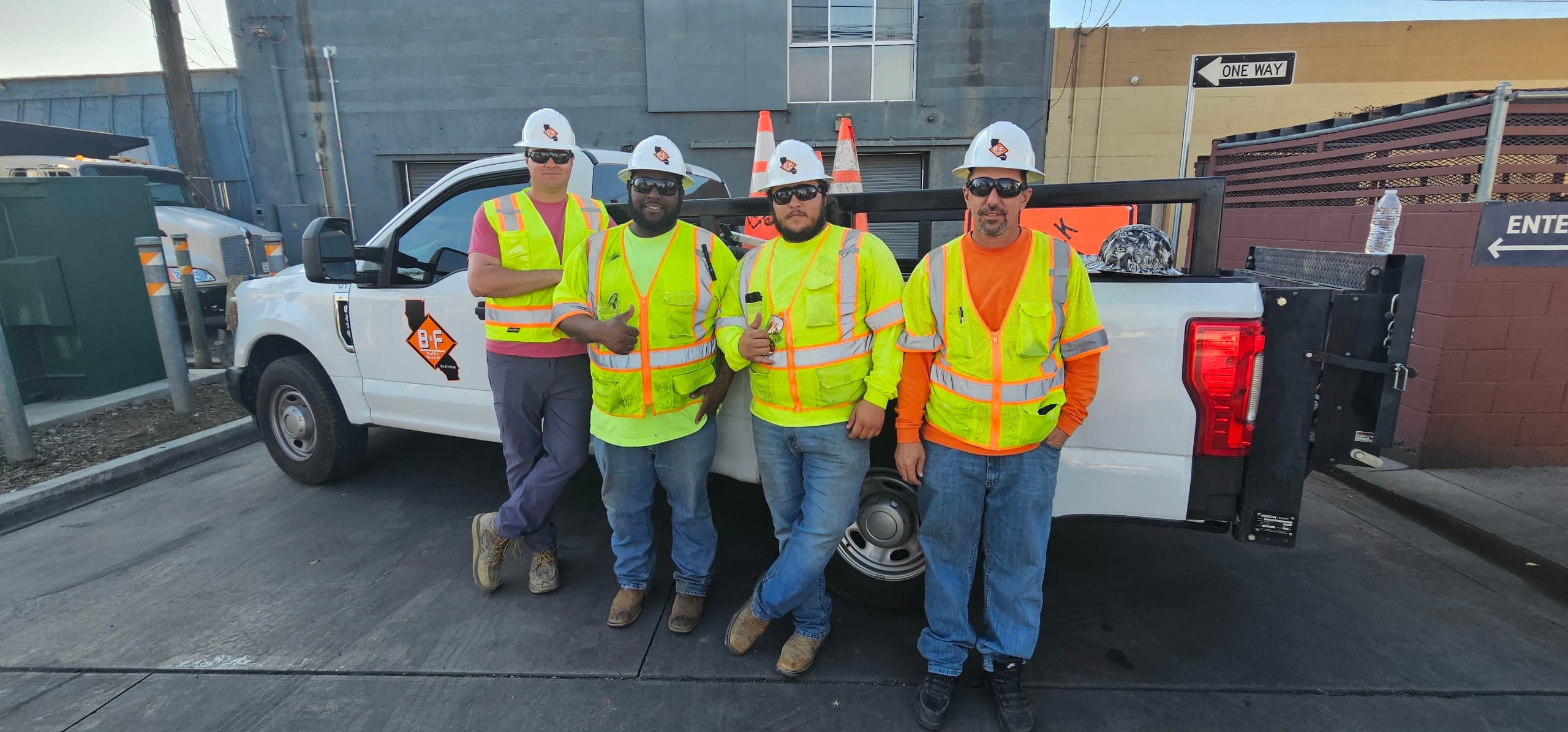The B&F Traffic Control crew in hard hats and high-visibility vests beside a company truck