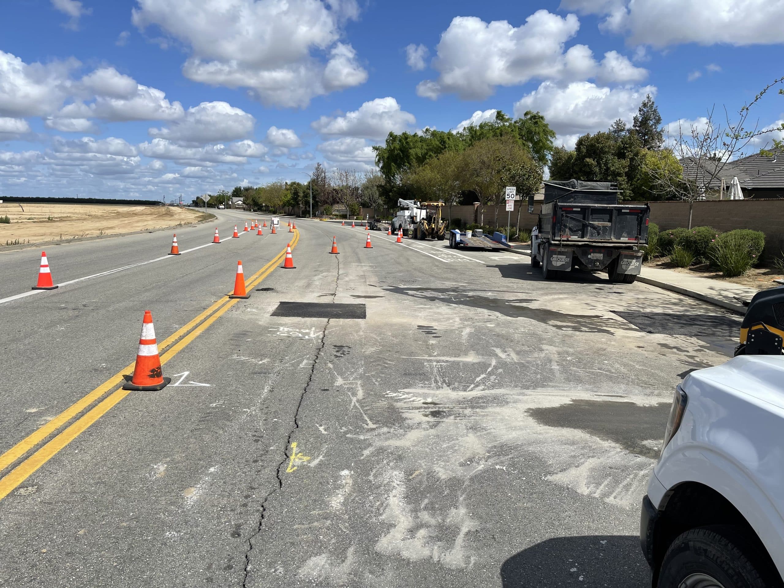 Traffic cones along a double yellow centerline on a two-lane road